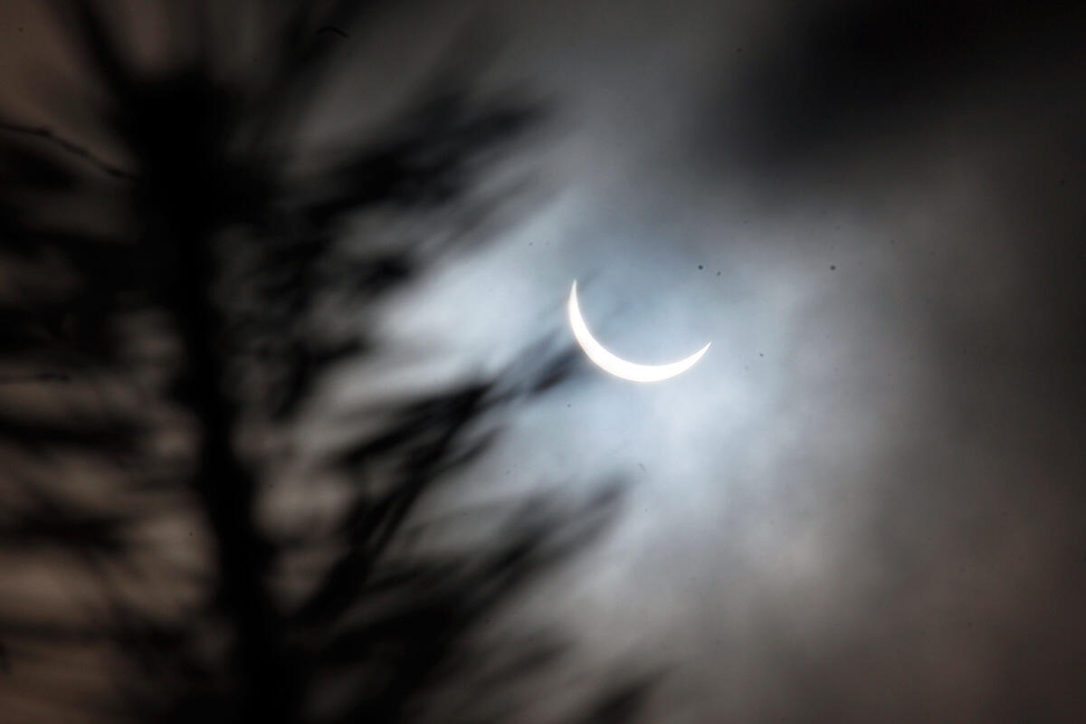 Photograph of a 86% solar eclipse taken through the clouds.